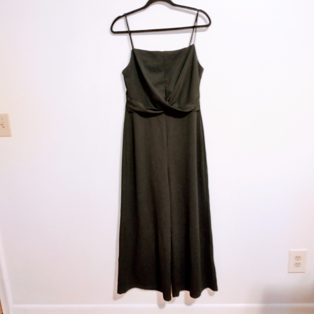 Lush black jumpsuit with twisted front detail. Spaghetti straps and wider legs s